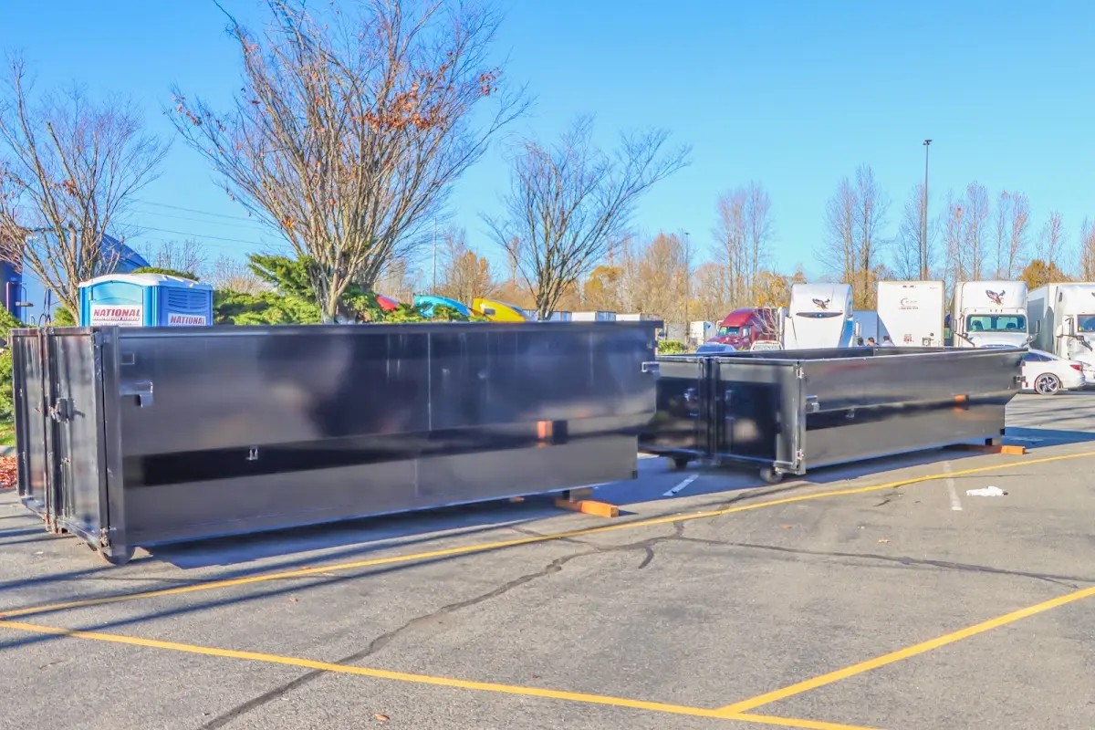 Professional dumpster rental service with roll-off container on residential driveway in Port Royal